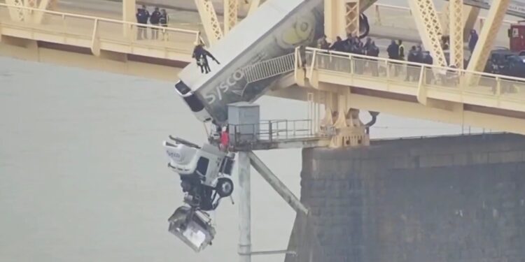 Truck Driver Miraculously Survives as Semi Dangles from Bridge Following Collision